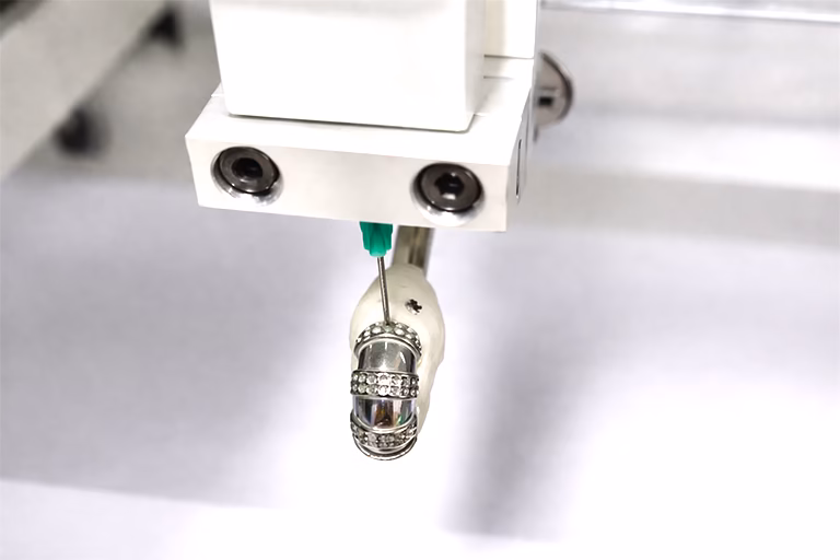 Precision machine applies glue to earrings Precision machine applies glue to earrings